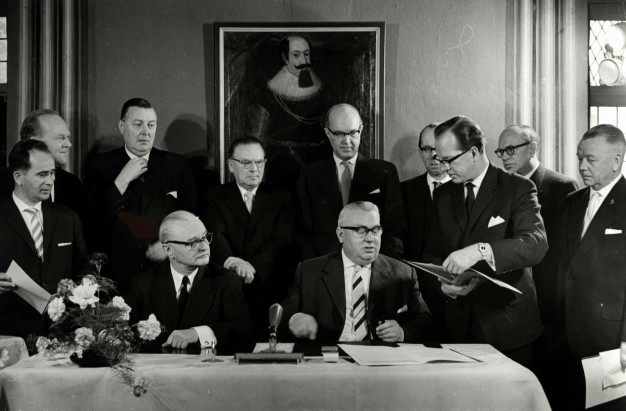Men signing a document