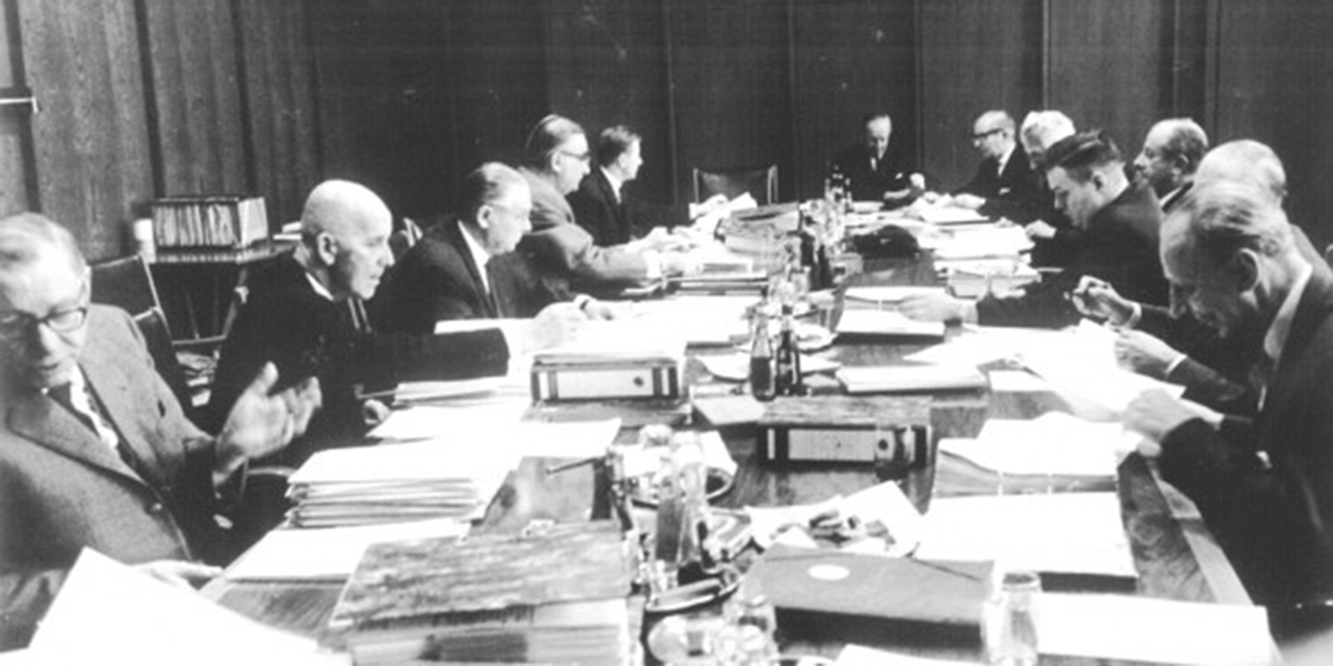 Men at the negotiating table with many documents